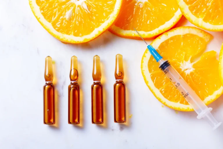 Vitamin ampoules and a syringe illustrating vitamin injections for nutritional gaps and low energy at Lotus Aesthetics.